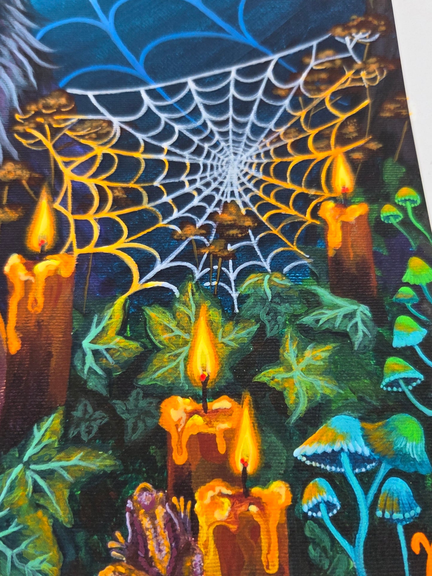 Spooky Halloween scene with cobweb, candles, and mushrooms on a dark background
