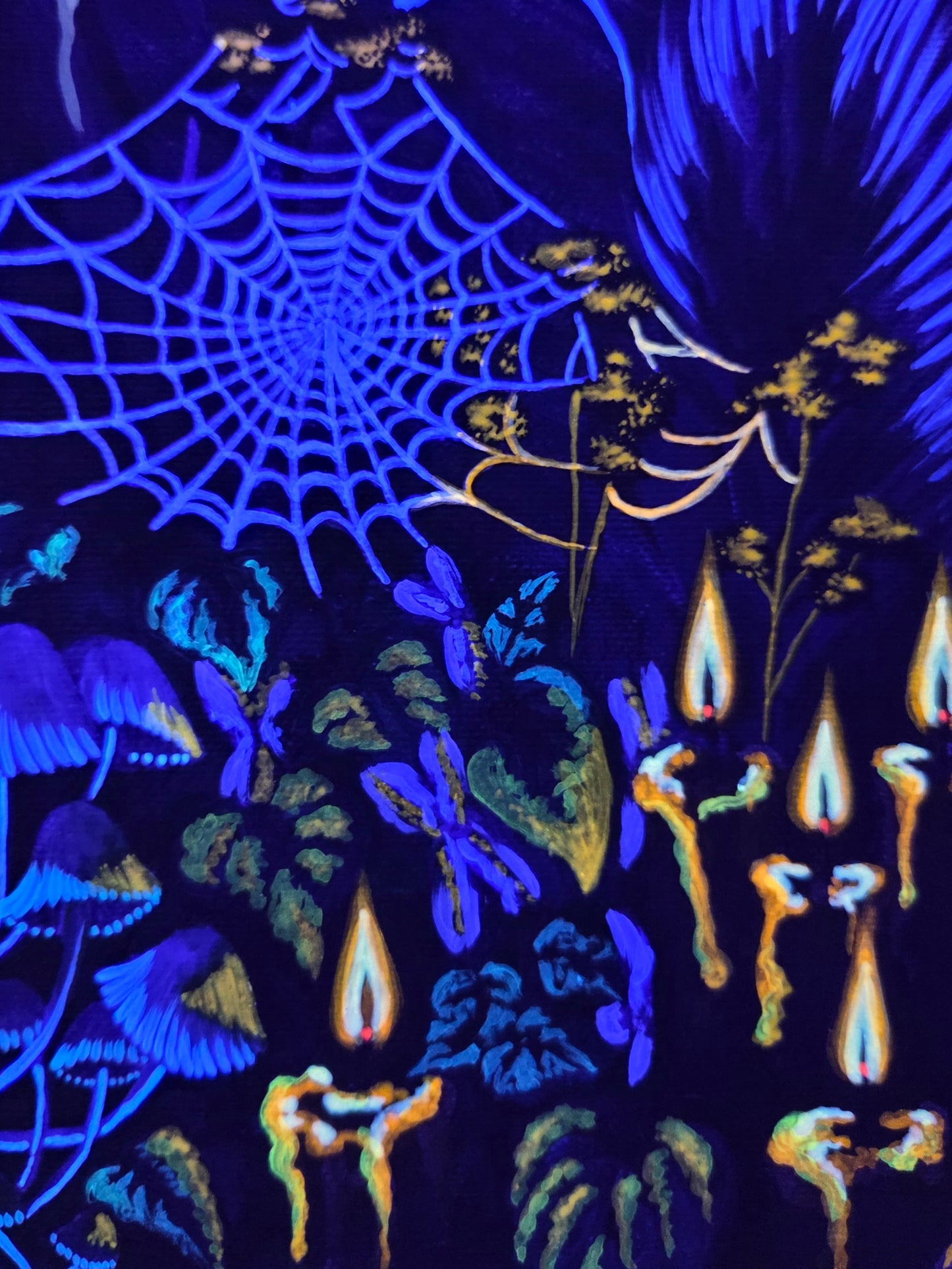 Halloween-themed fabric with spider web, candles, and skeletons on a dark background