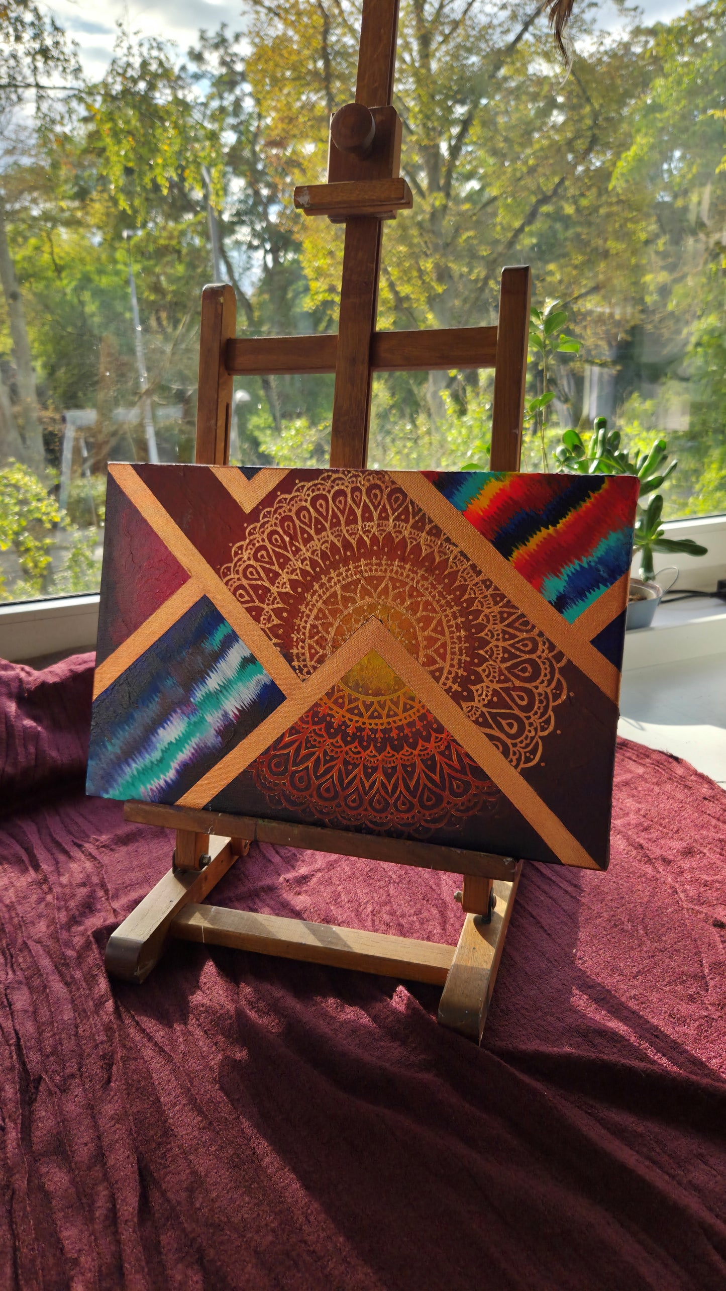 Radiant Geometries original mandala painting by Tori Nagay in daylight – sacred geometry and vibrant colors on canvas.