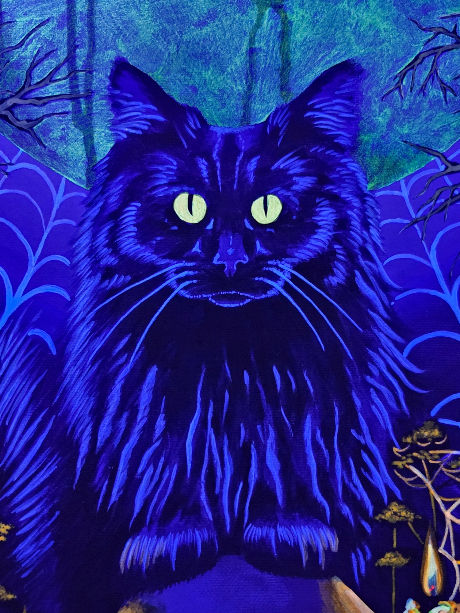 Black cat with glowing eyes on a blue and green background